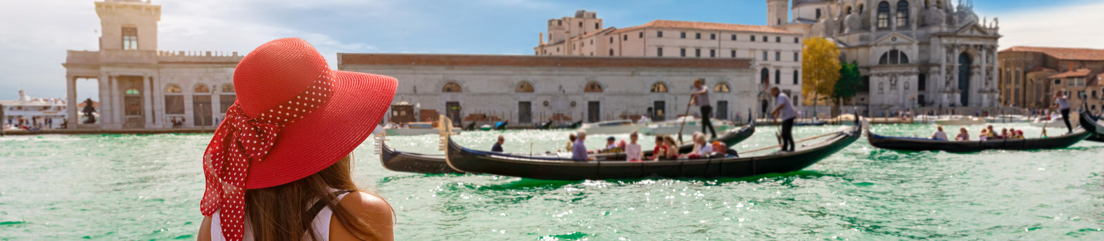 Female tourist looking the Basilica di Santa Maria della Salute and Canale Grande in Venice, Italy