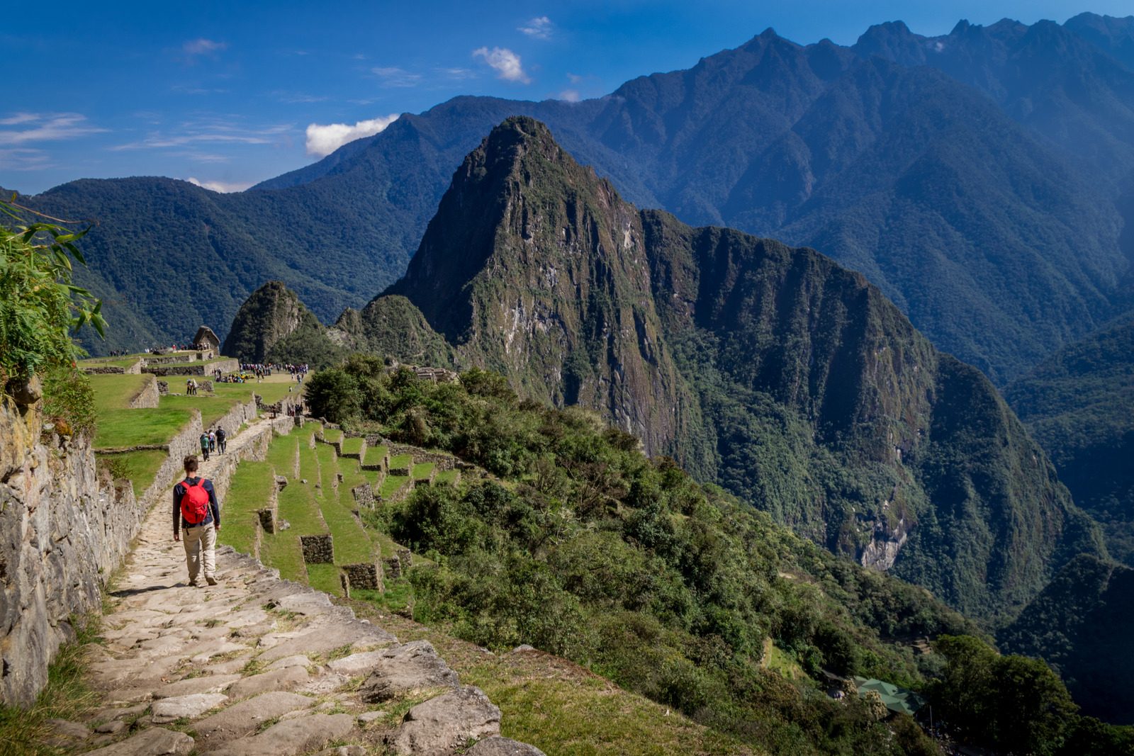 Man walking the Inca trail, the Huayna Picchu mountains behind. UNESCO World Heritage. Peru, South America